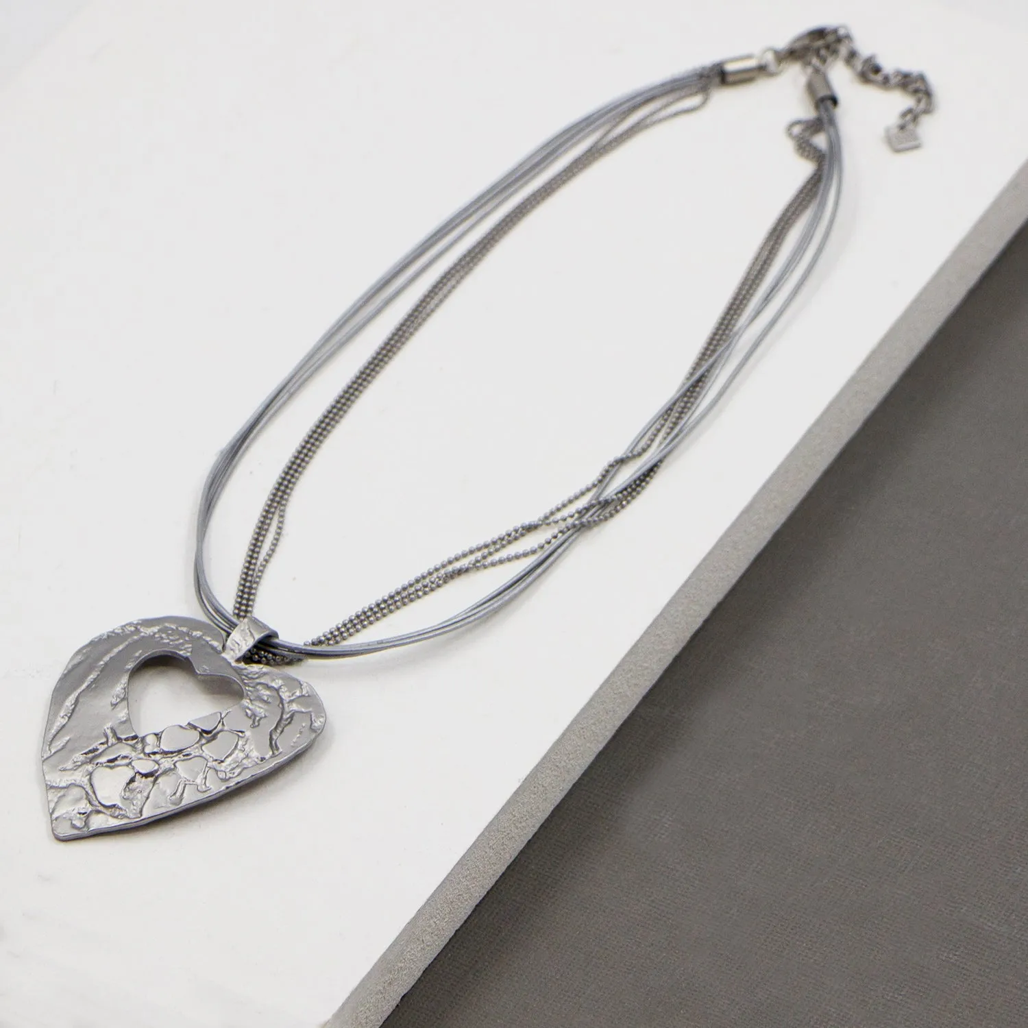 Contemporary cut out heart with leather & chain necklace
